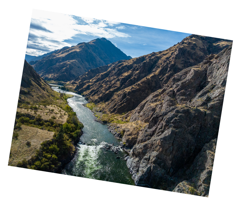 Landing Page A polaroid photo featuring a sweeping view of the rugged Hells Canyon Dam along the Snake River landscape.
