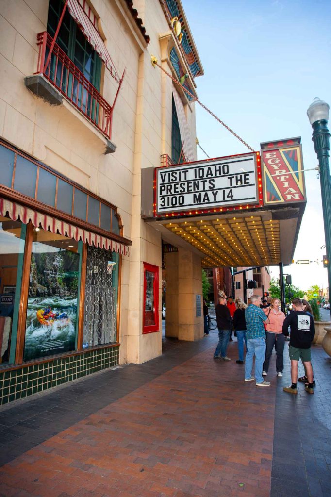 Landing Page A glowing marquee on the Egyptian Theatre reads ‘Visit Idaho Presents The 3100, May 14’ as a crowd gathers beneath the lights.